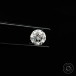 Bright round nova cut lab diamond shown in side angled tweezers view