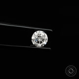 Bright round nova cut lab diamond shown in side angled tweezers view