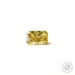 Rectangular radiant yellow lab diamond resting flat white background