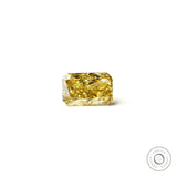 Rectangular radiant yellow lab diamond resting flat white background