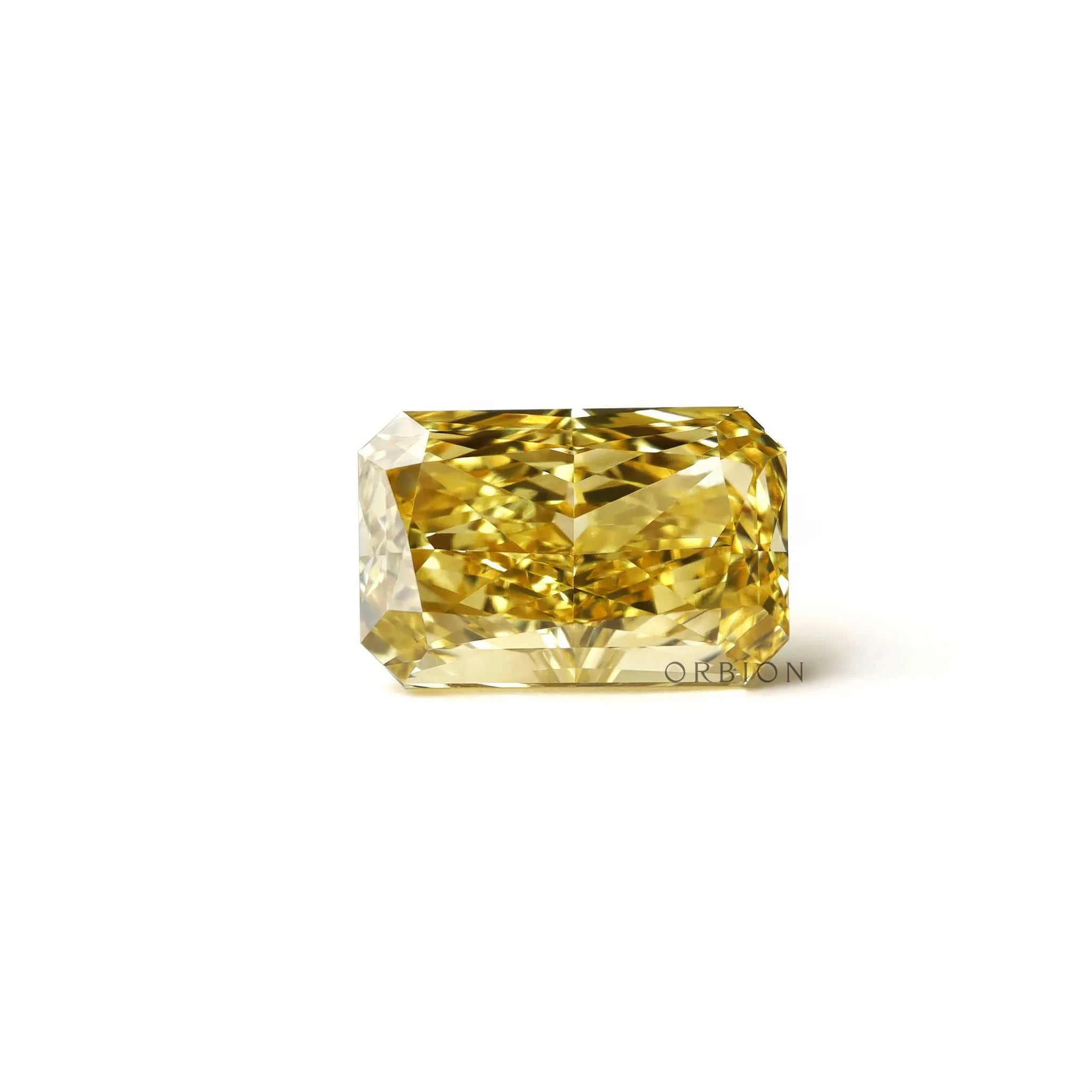 Rectangular radiant yellow lab diamond resting flat white background