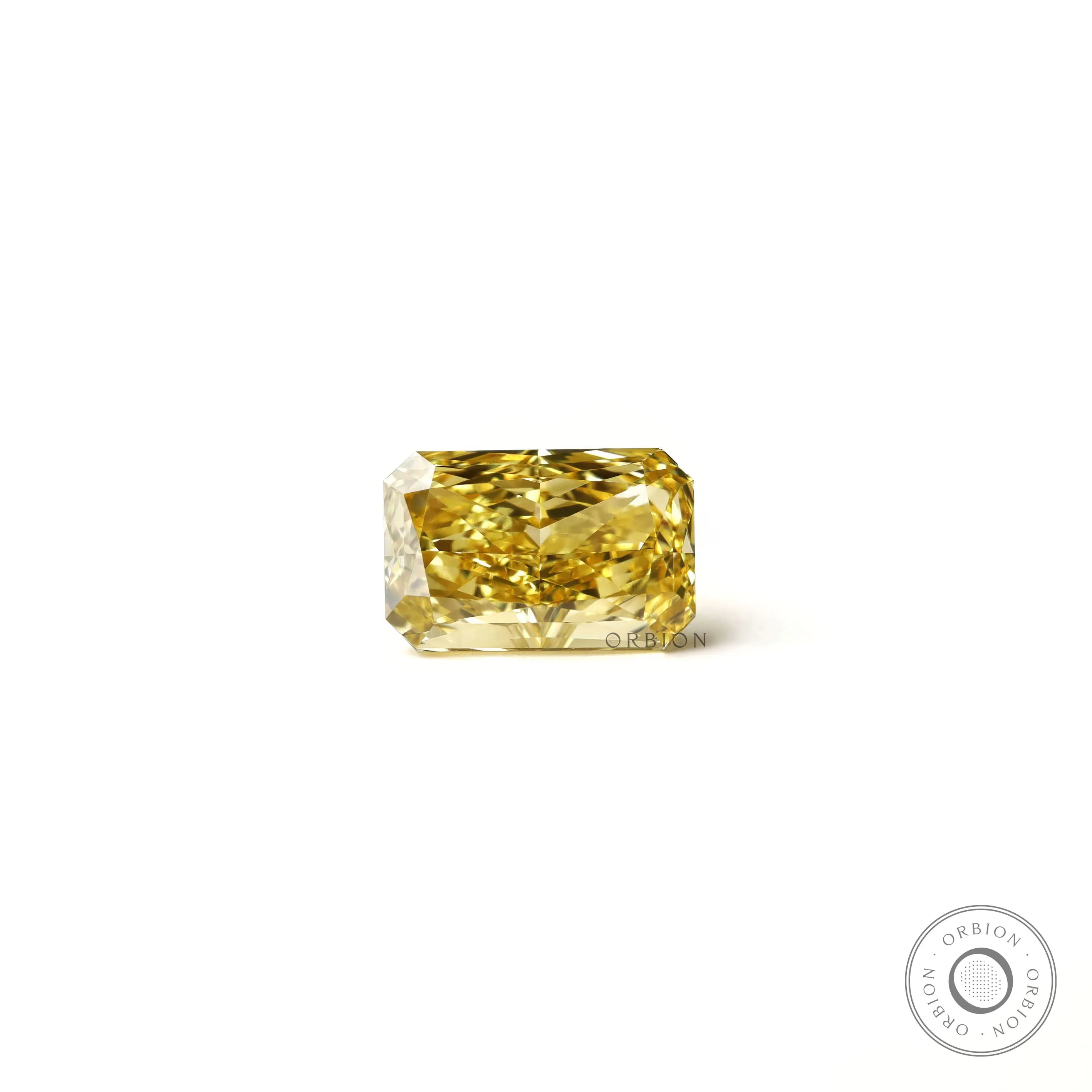 Rectangular radiant yellow lab diamond resting flat white background