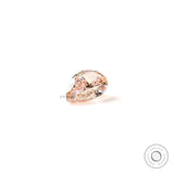 Pear shaped pink lab diamond resting on white background