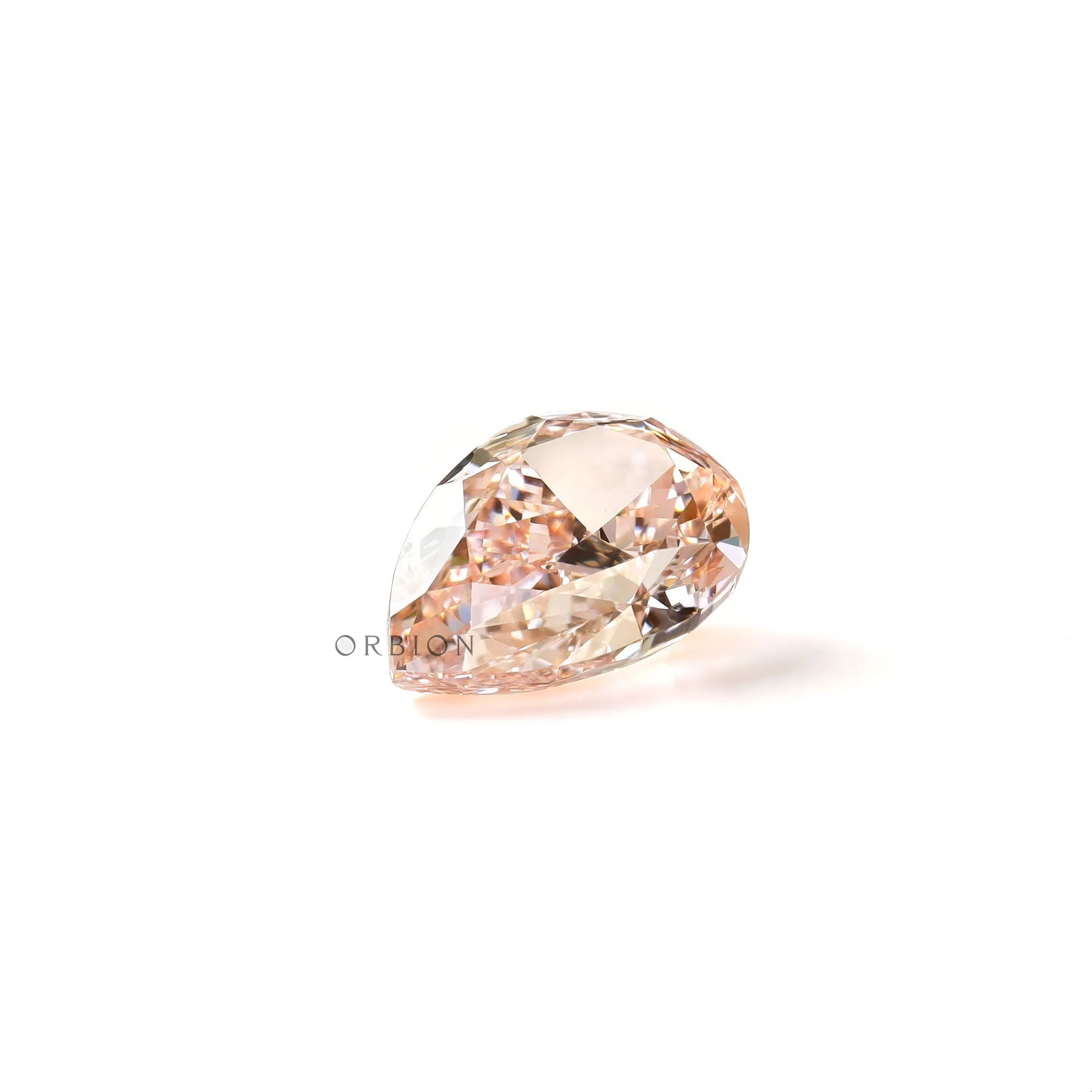 Pear shaped pink lab diamond resting on white background