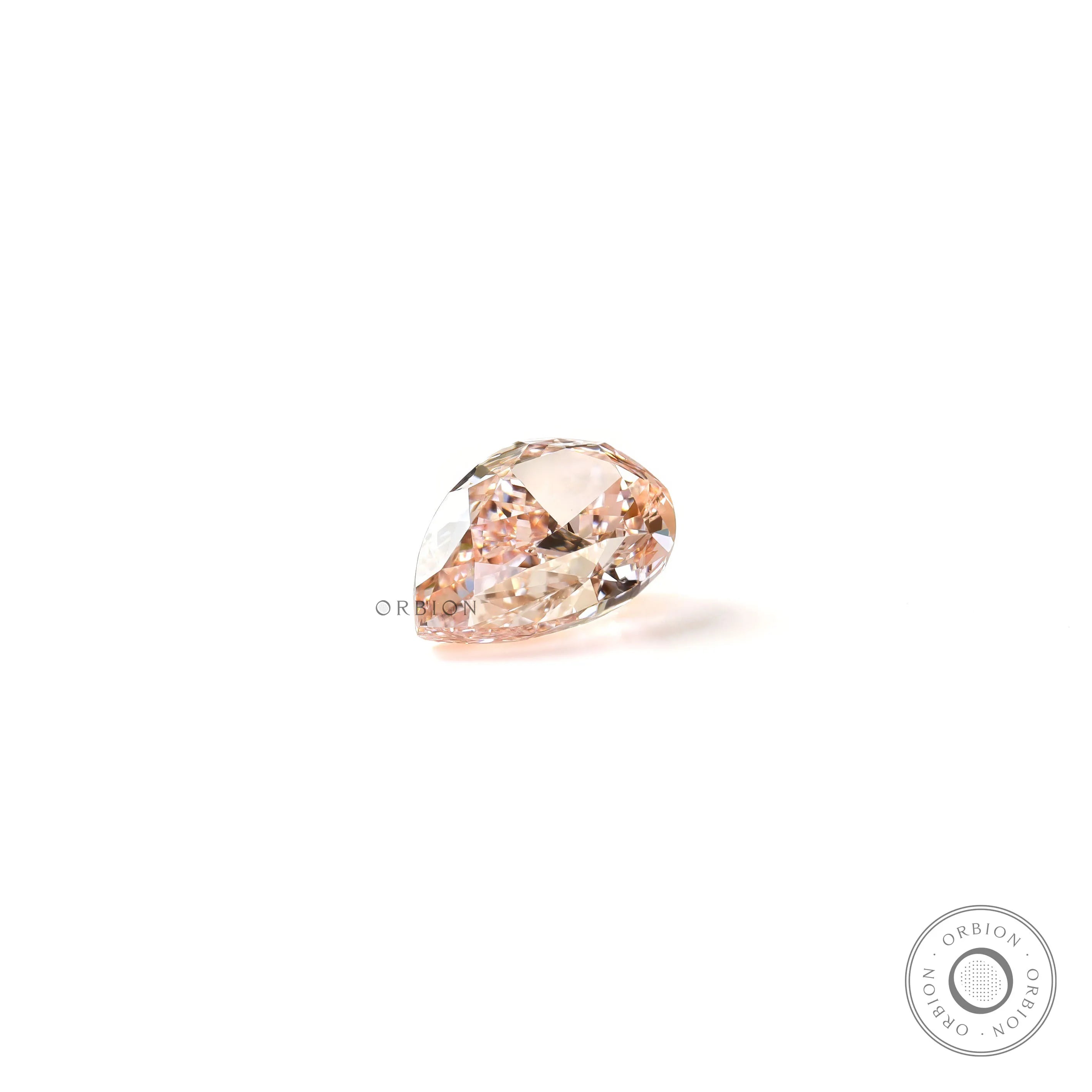 Pear shaped pink lab diamond resting on white background