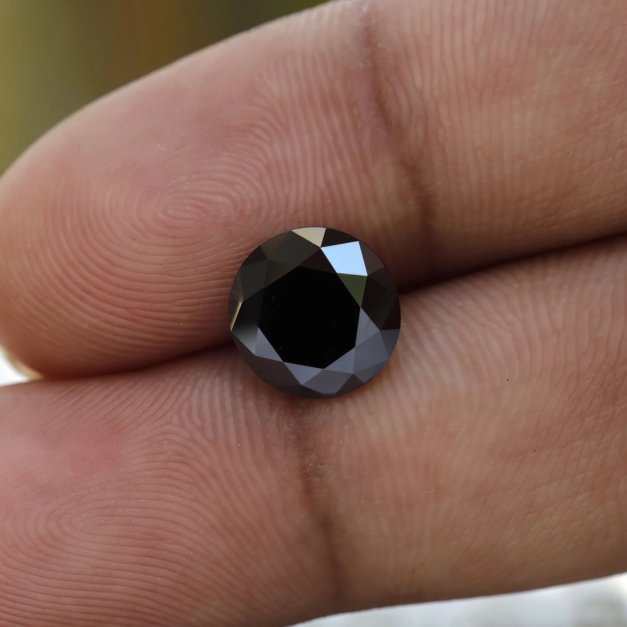 2 CT Old European Cut Black Moissanite in hand
