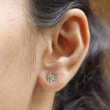 Model wearing lotus flower stud earrings with yellow lab diamond