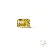 Fancy intense yellow radiant diamond resting flat white background