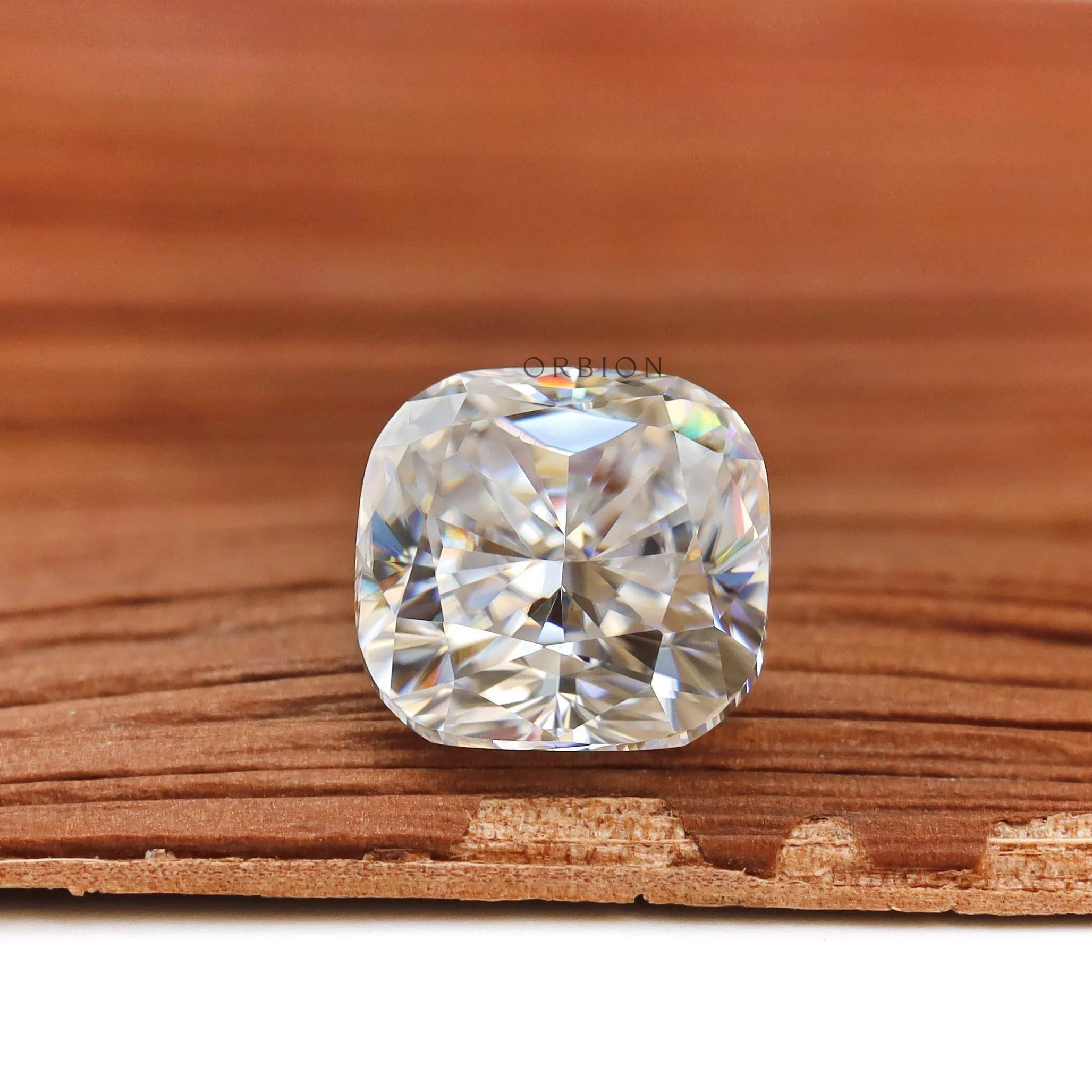 Side profile cushion brilliant cut loose moissanite on wood