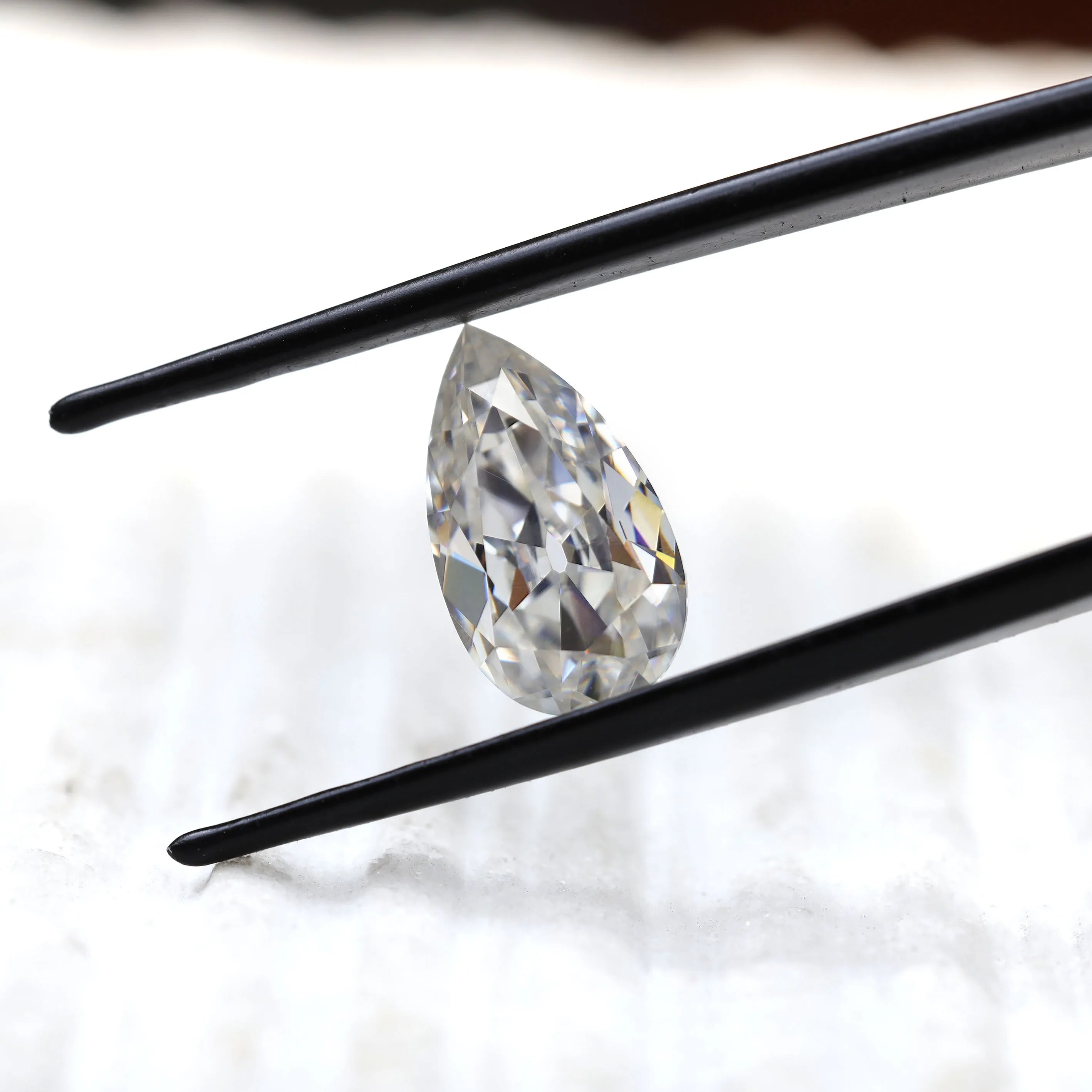 DEF pear moissanite shown at slight side angle