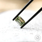 Side angled view of green emerald cut lab diamond