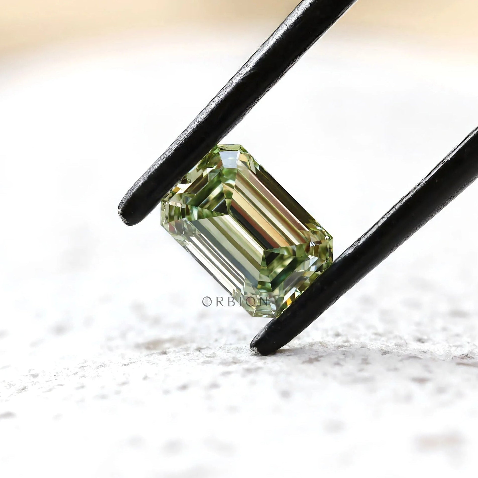 Side angled view of green emerald cut lab diamond
