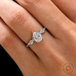 Finger view of pear Moissanite engagement ring on hand