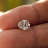 1.35 CT Old Mine Cut Moissanite Off White Pear stone in hand held