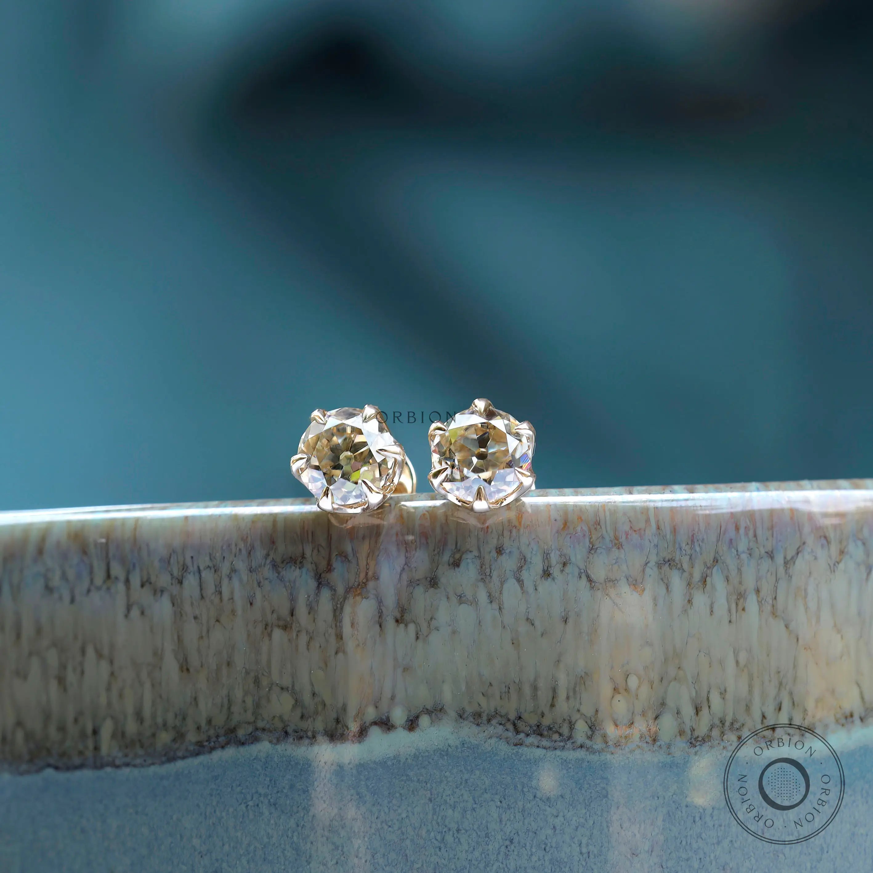 Display edge view OEC champagne moissanite stud earrings