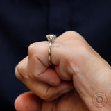 Side wear view of solitaire moissanite ring on hand