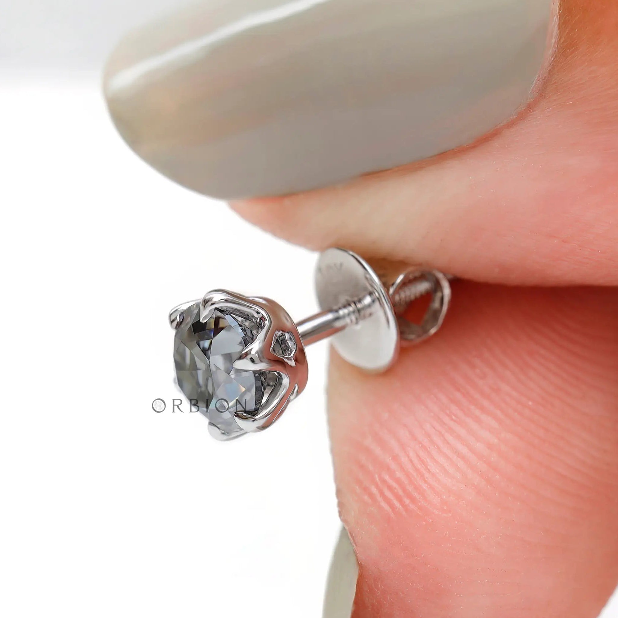 Handheld angled view detail grey moissanite claw prong stud