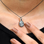 Georgian pear moissanite pendant worn on oxidized silver chain