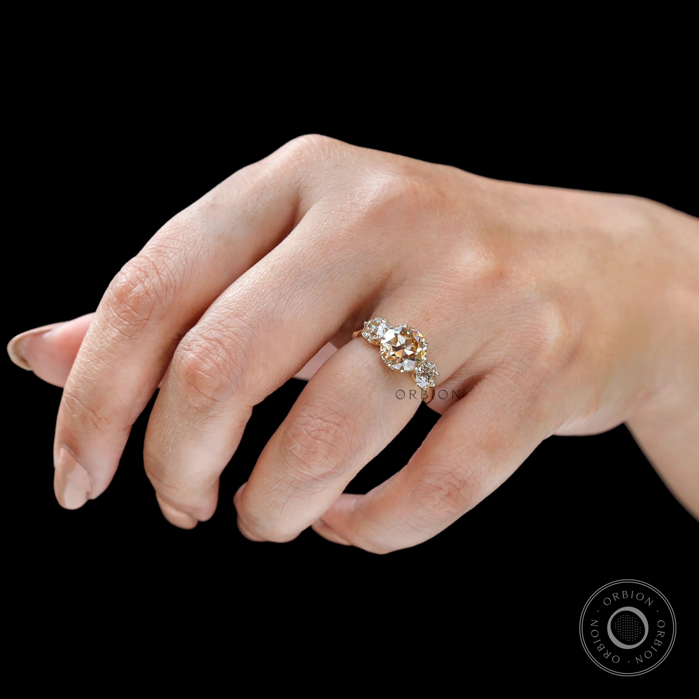 Top wear view champagne moissanite three stone ring on hand