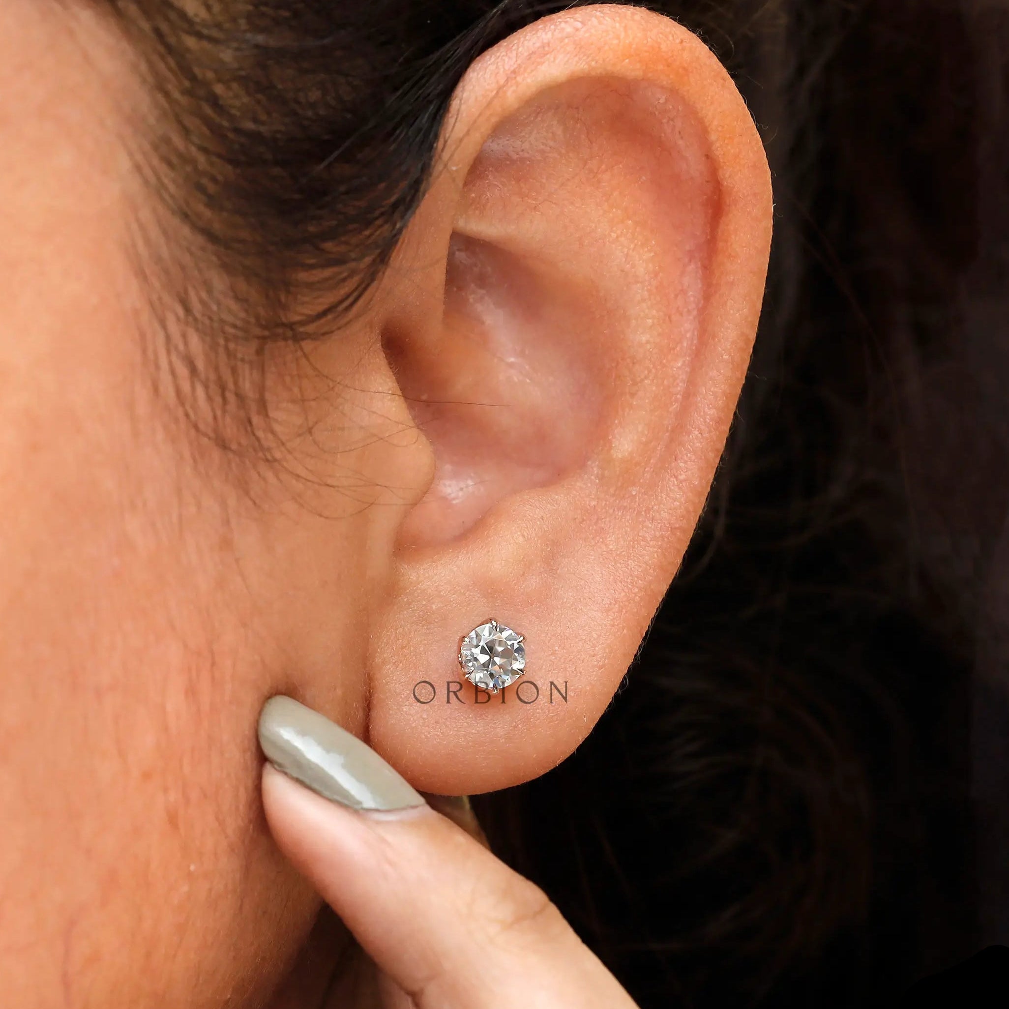 Worn view old European cut moissanite stud earrings