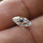 Elegant marquise moissanite stone held between fingers