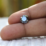 Sparkling 2 CT Round Black Moissanite stone on hand