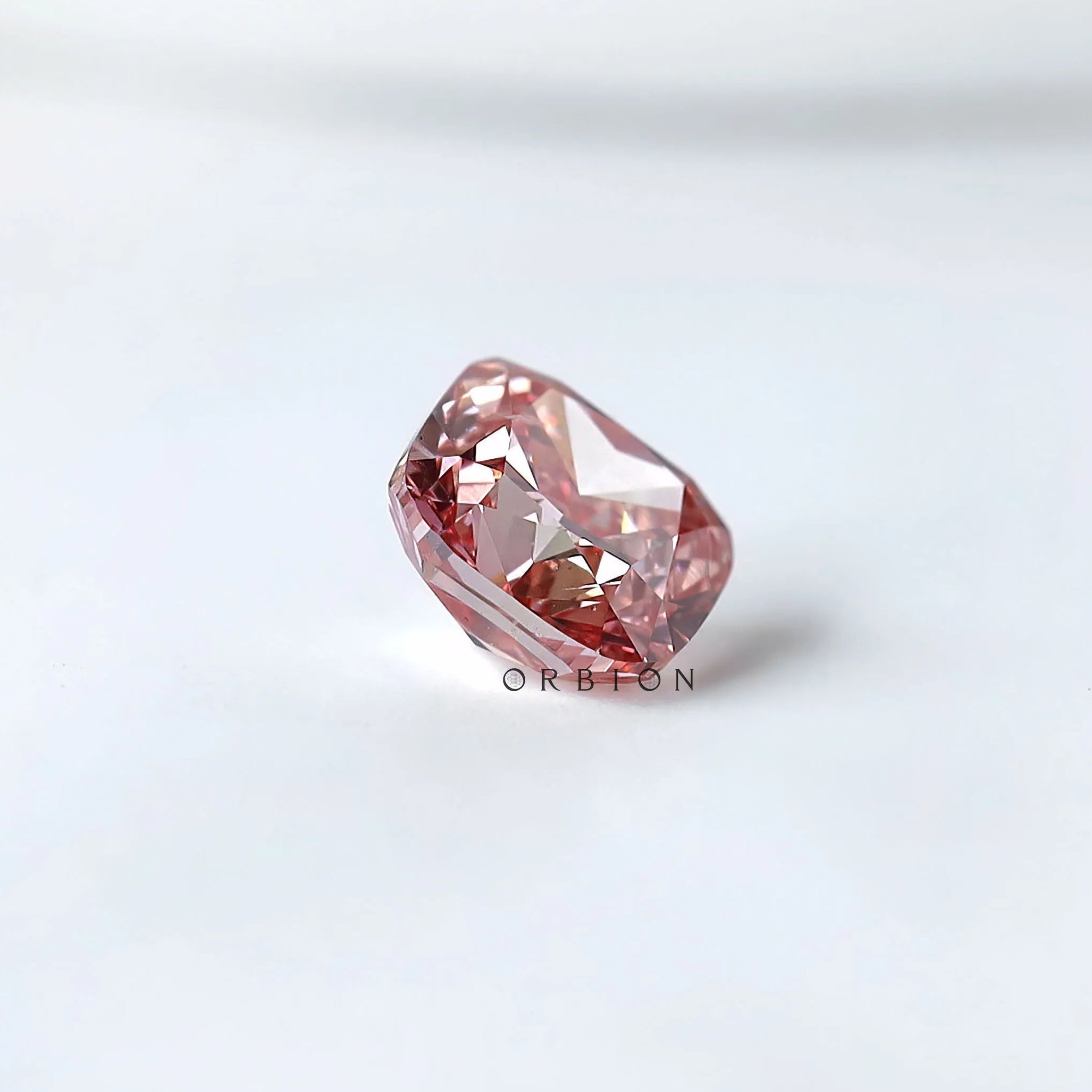 Side angled profile of purplish pink cushion loose lab diamond