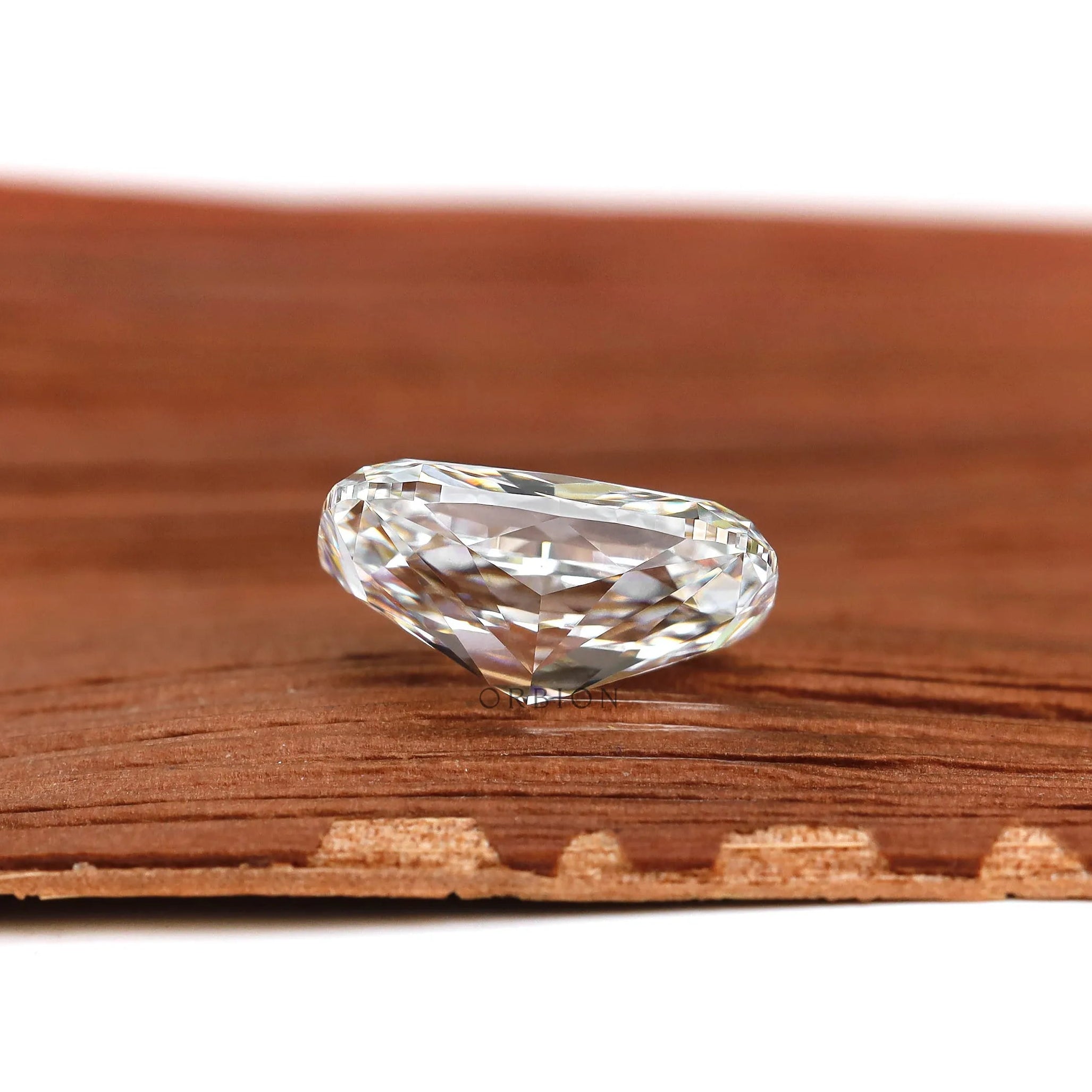 Side profile elongated cushion brilliant cut lab diamond on wood