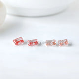 Row display of four radiant pink loose diamonds