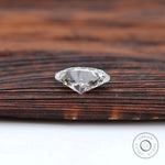 Brilliant cut oval loose diamond resting on wooden tray