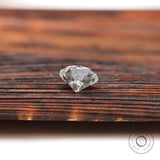 Bottom view of round loose lab diamond on wooden background
