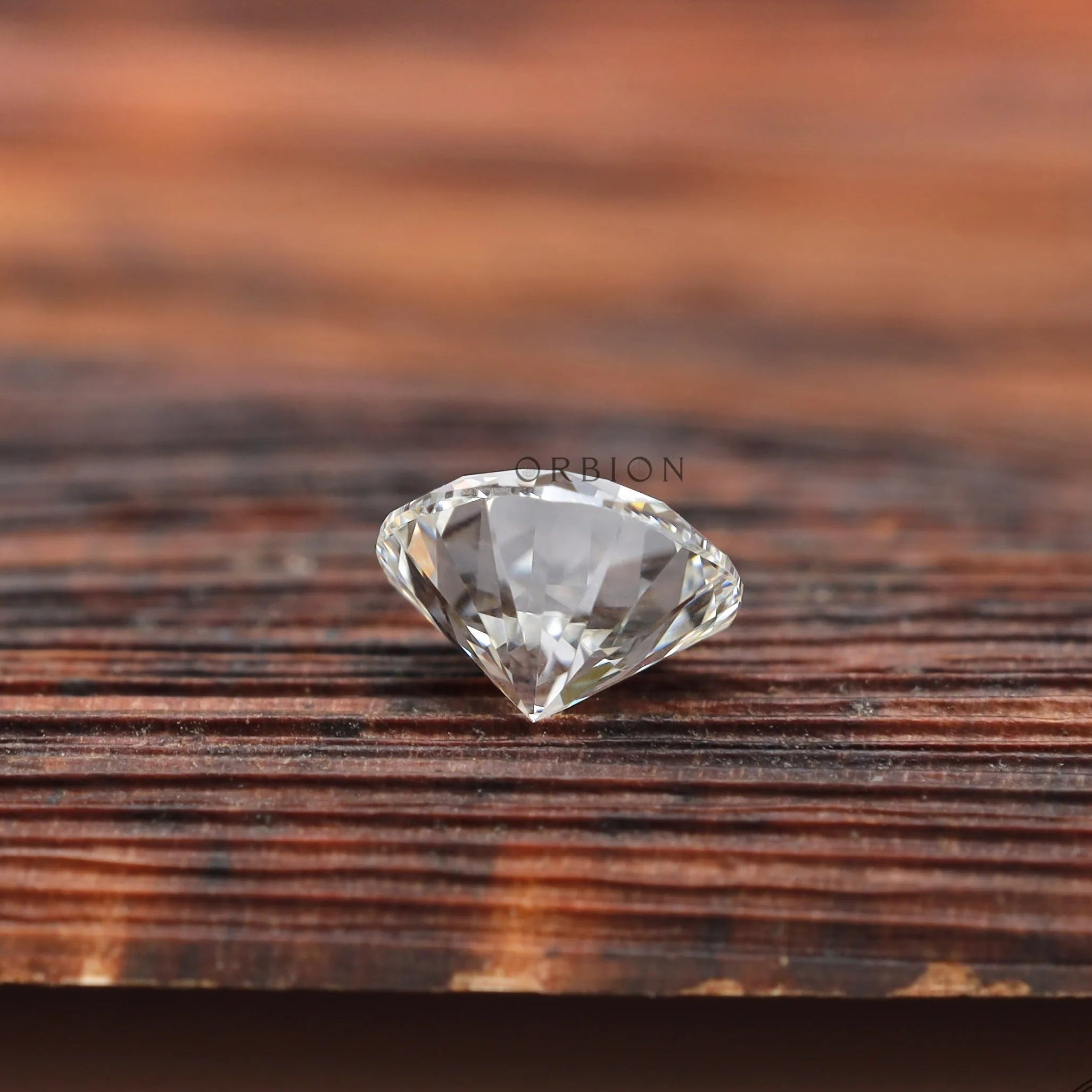 Bottom view of round loose lab diamond on wooden background