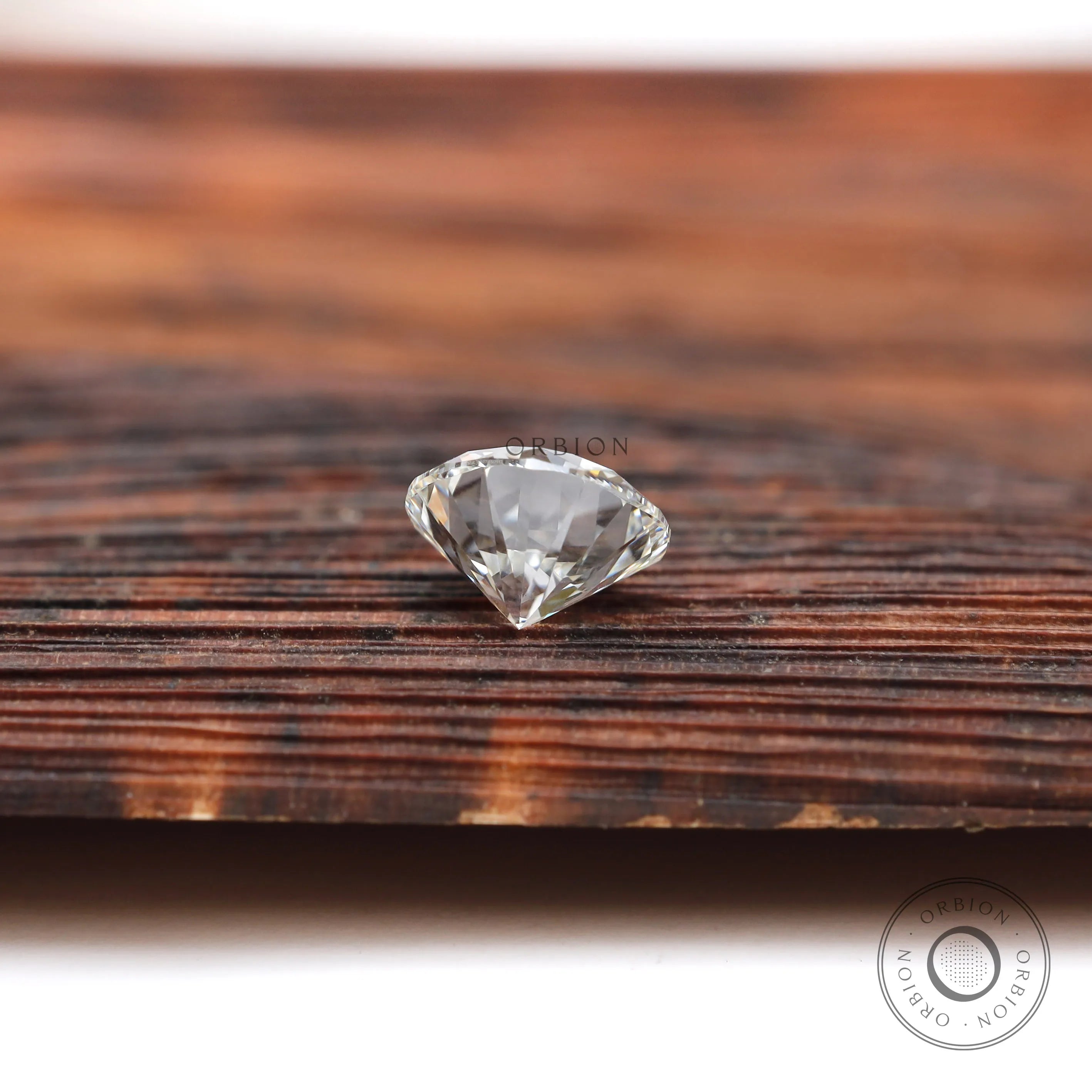 Bottom view of round loose lab diamond on wooden background