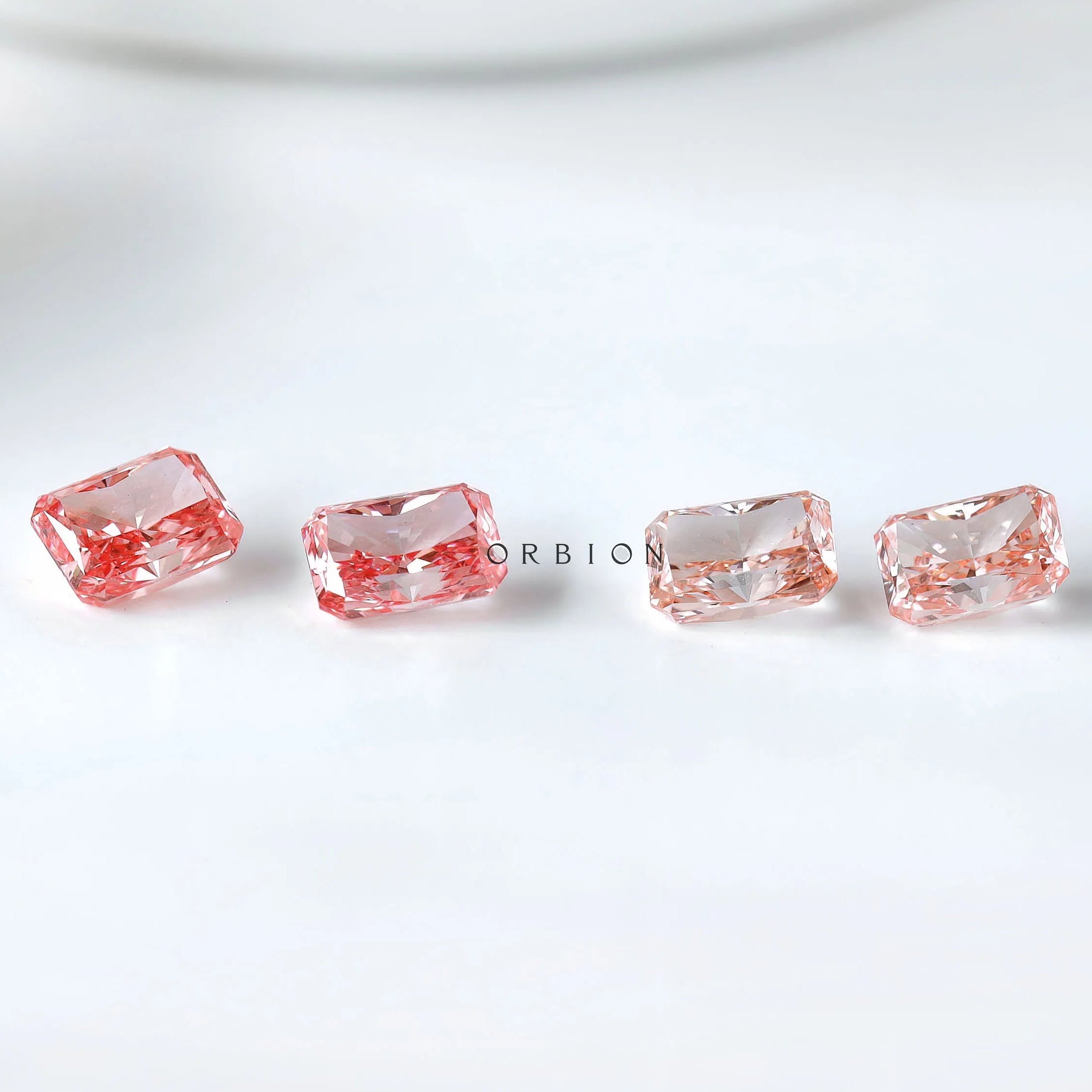Row of radiant pink loose lab diamond pairs