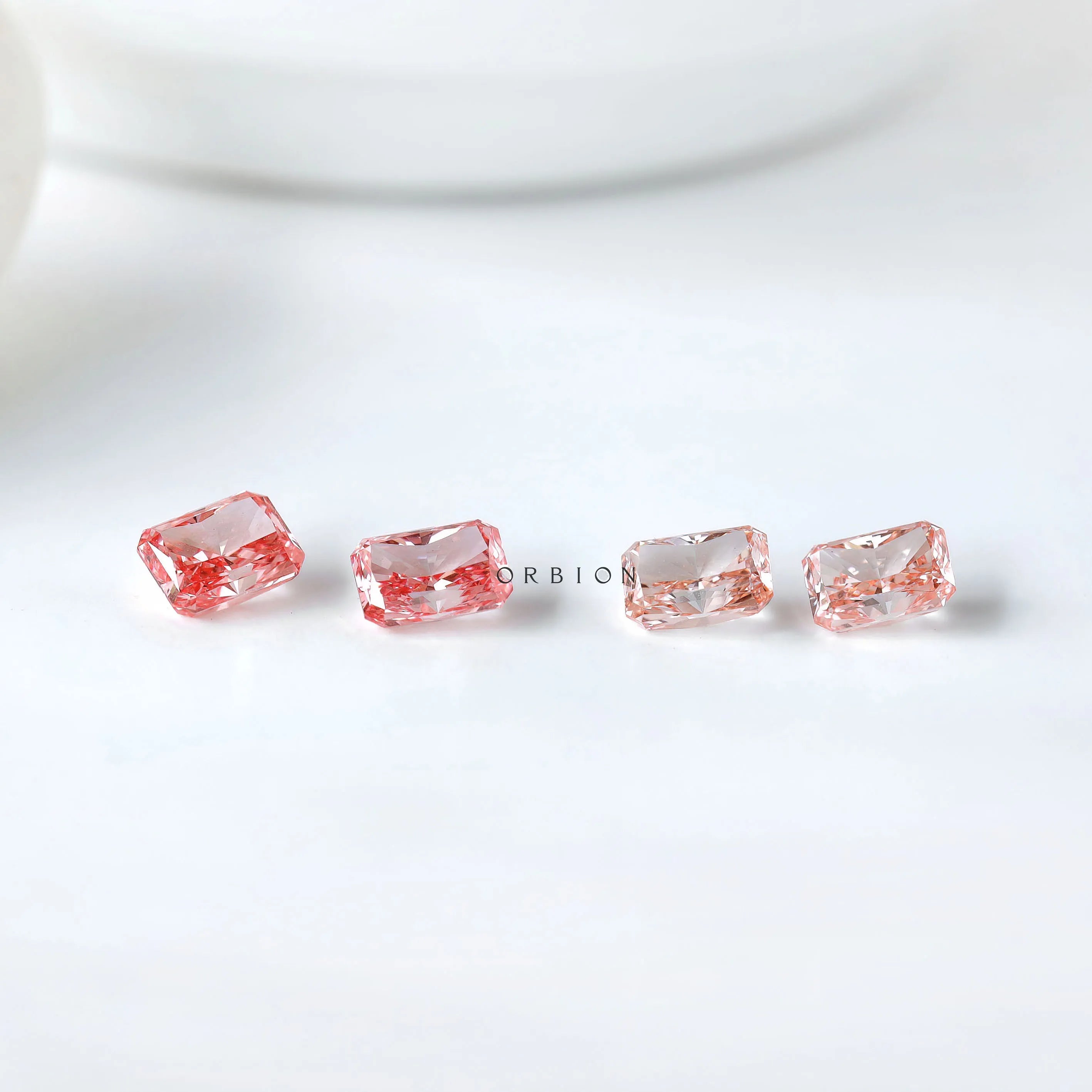 Row of radiant pink loose lab diamond pairs