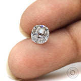 Elongated cushion loose moissanite displayed on fingertips for scale
