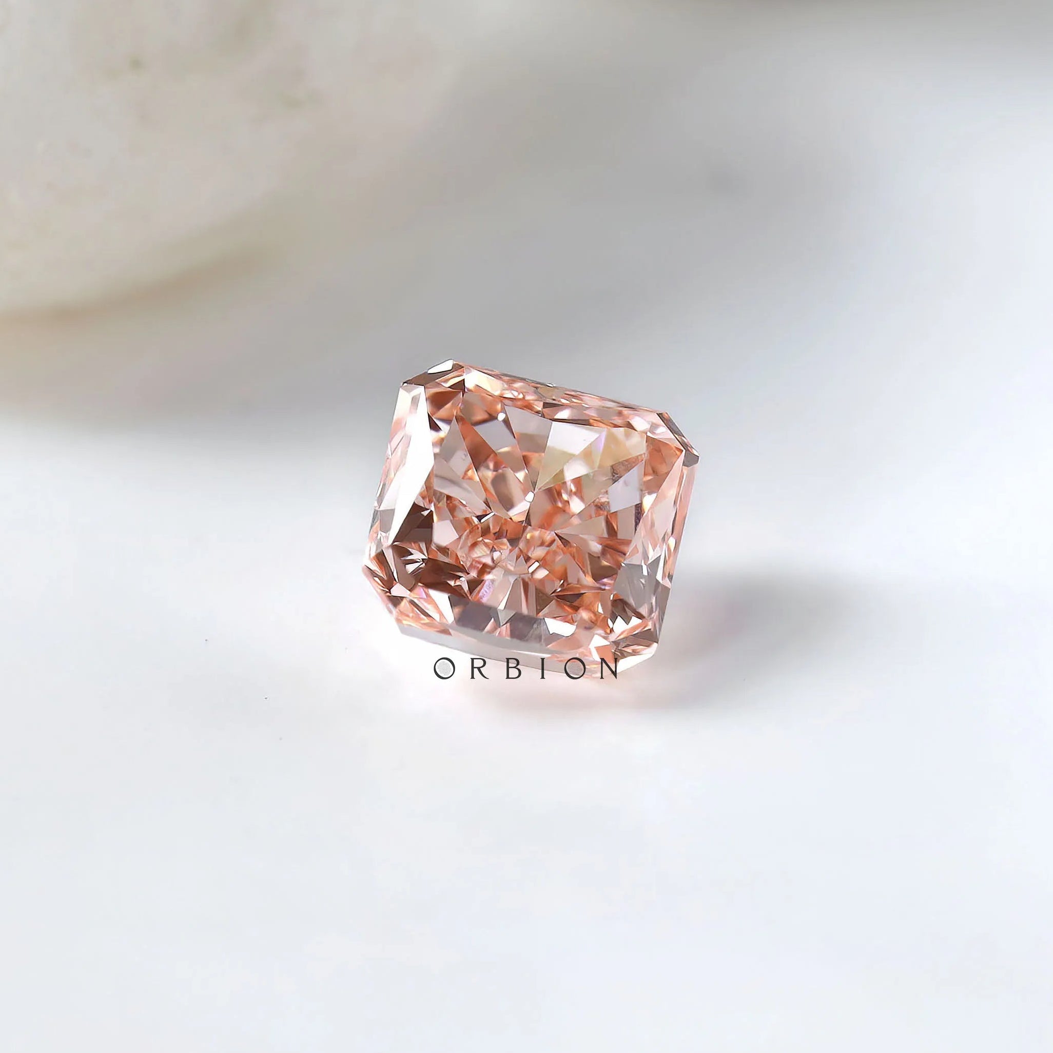 Radiant brilliant pink loose diamond with soft white background