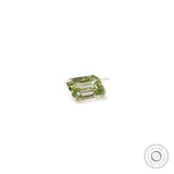 Emerald cut fancy green loose diamond resting flat