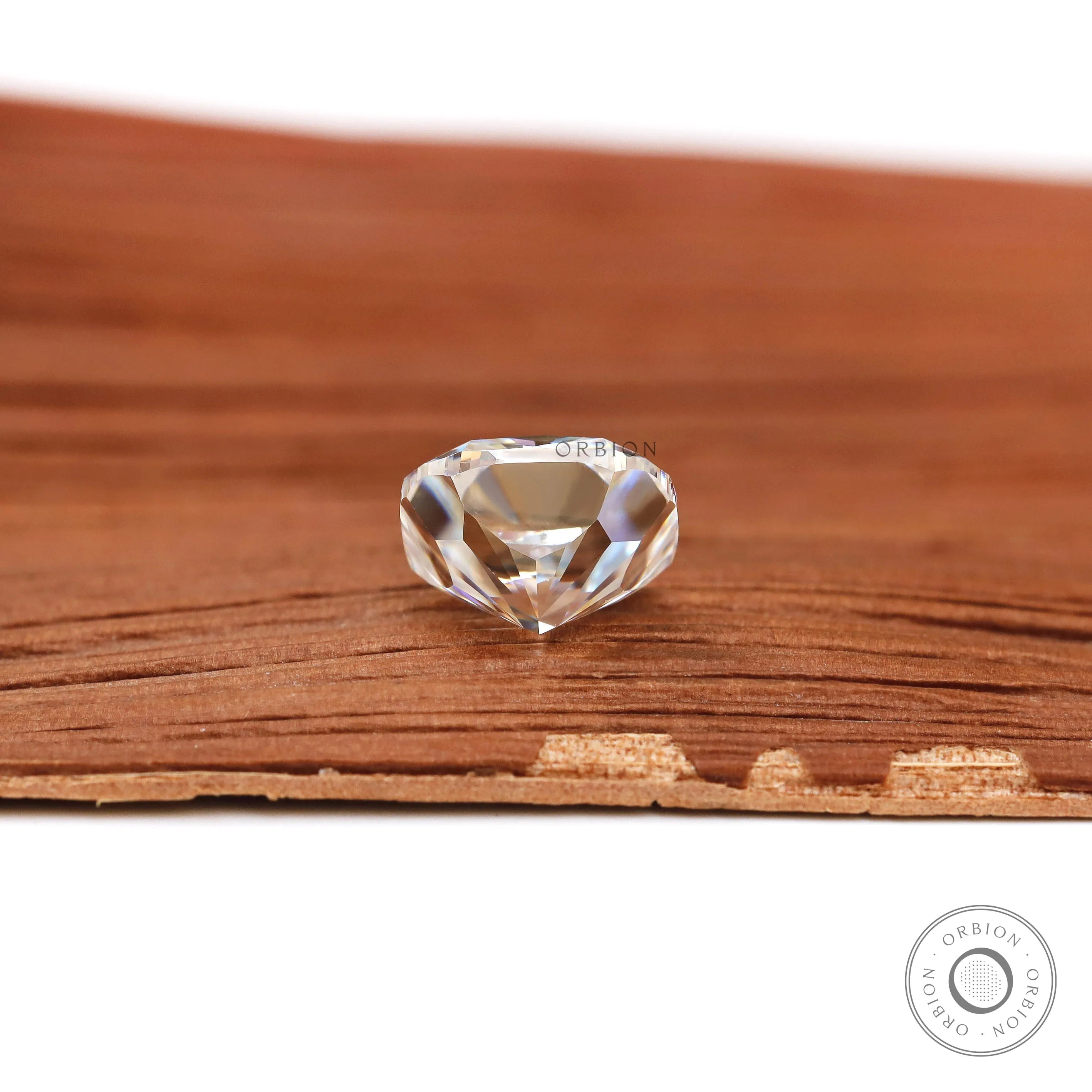 Bottom profile cushion brilliant cut loose moissanite on wood