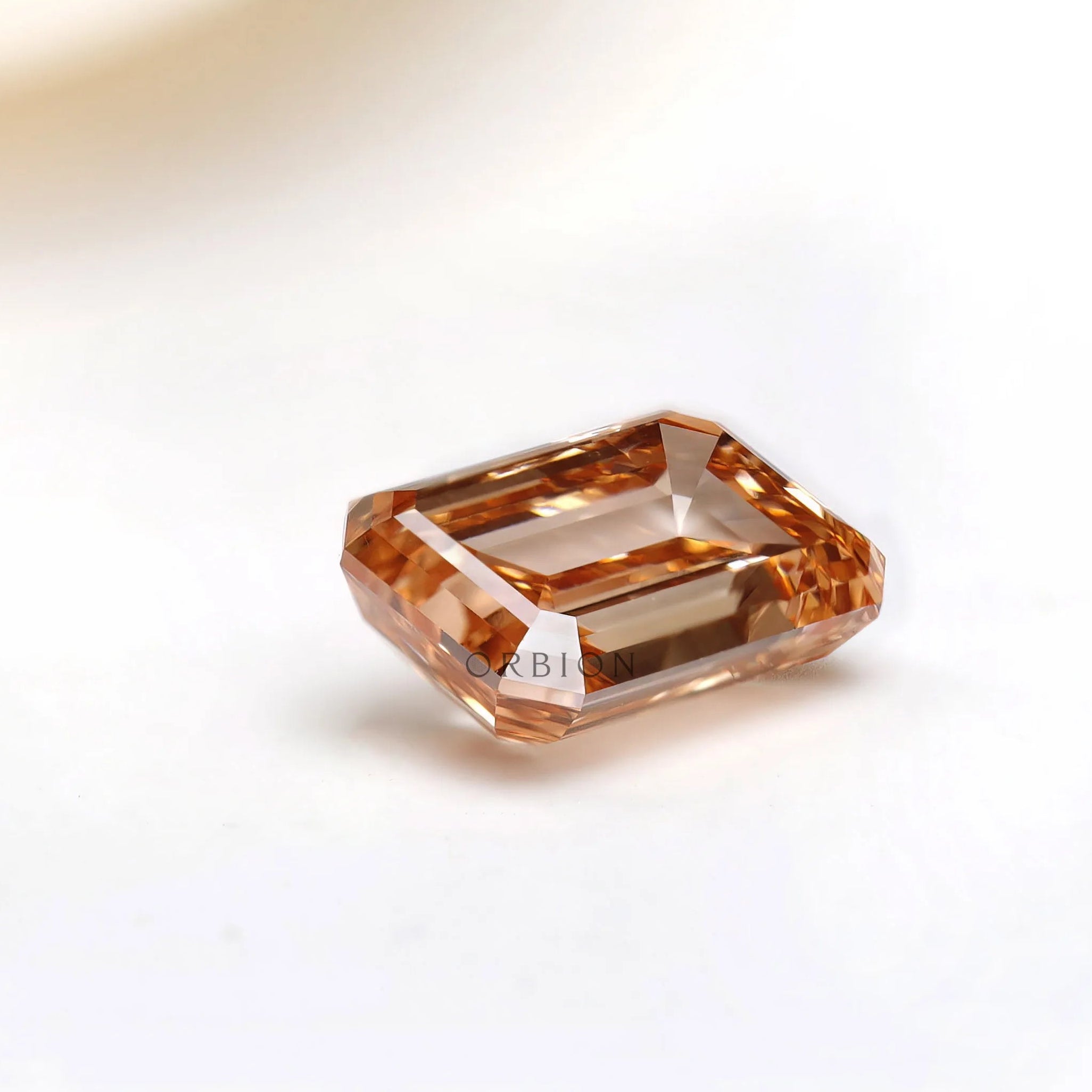 Side angle of fancy orange emerald cut diamond