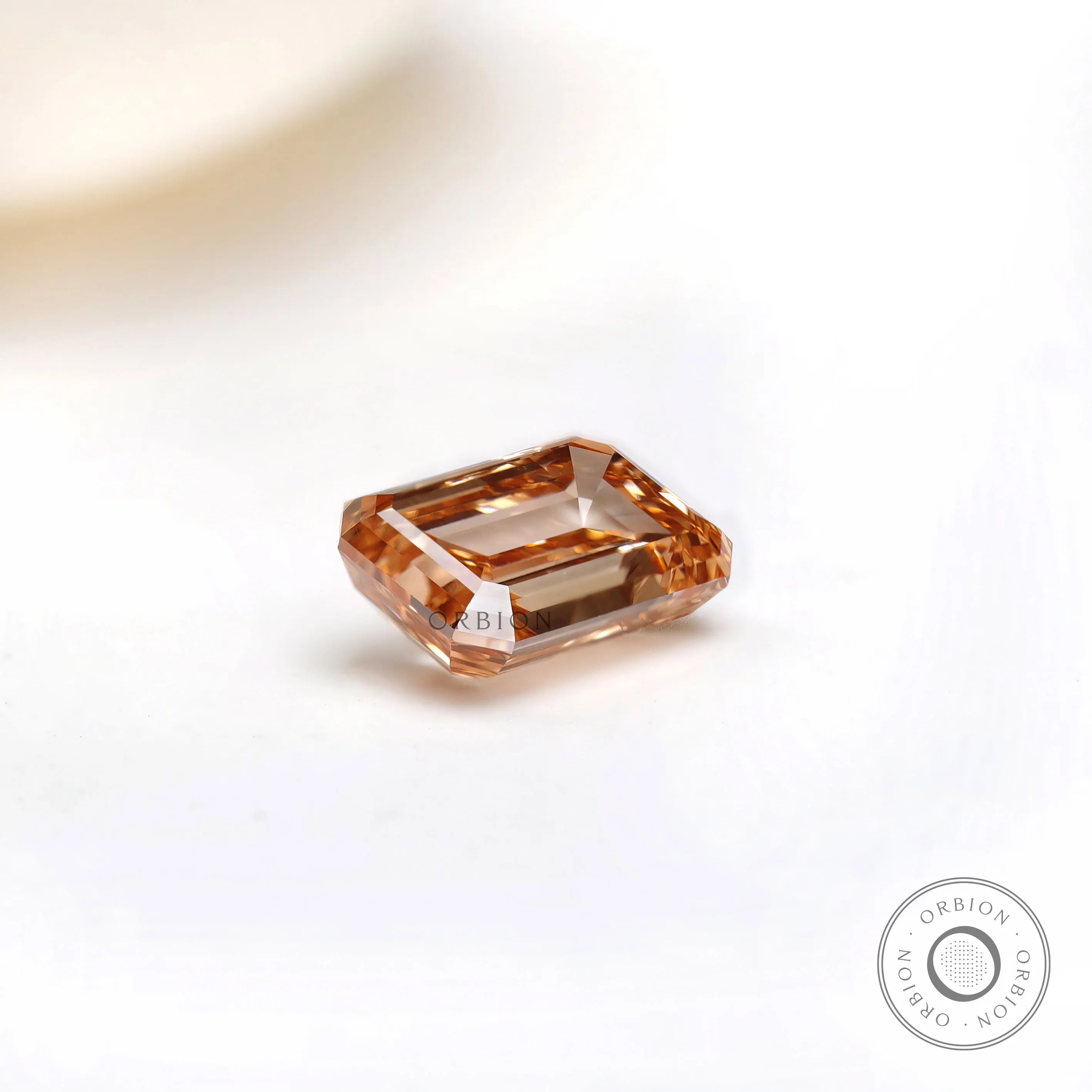 Side angle of fancy orange emerald cut diamond