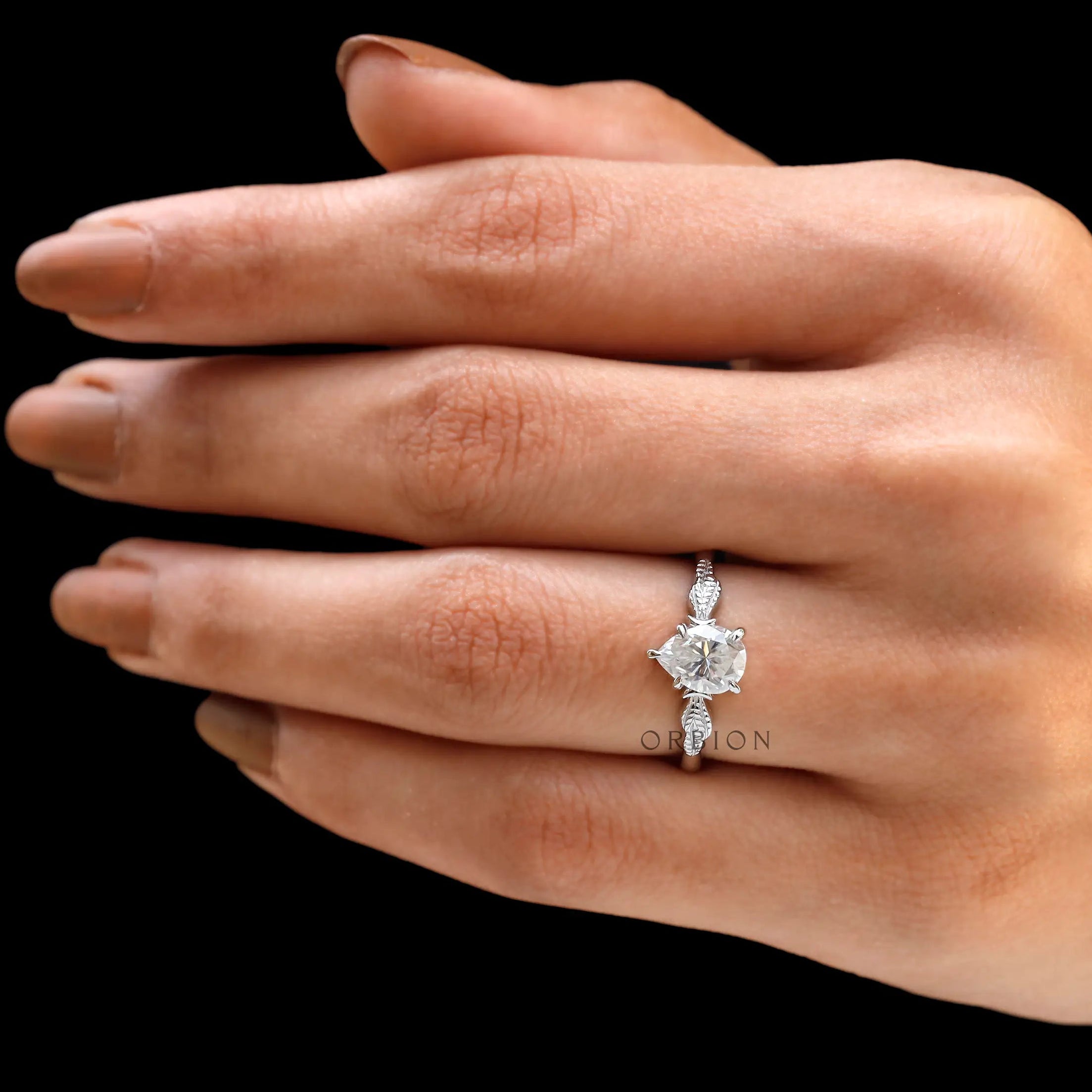 Detailed view of the Art Nouveau leaf design on engagement ring
