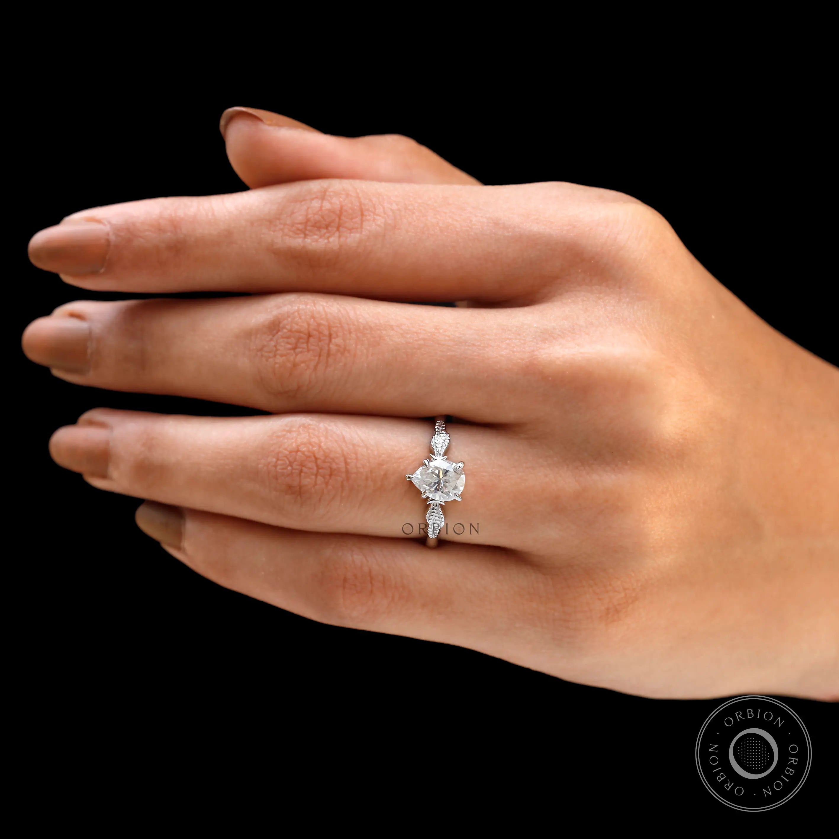 Detailed view of the Art Nouveau leaf design on engagement ring