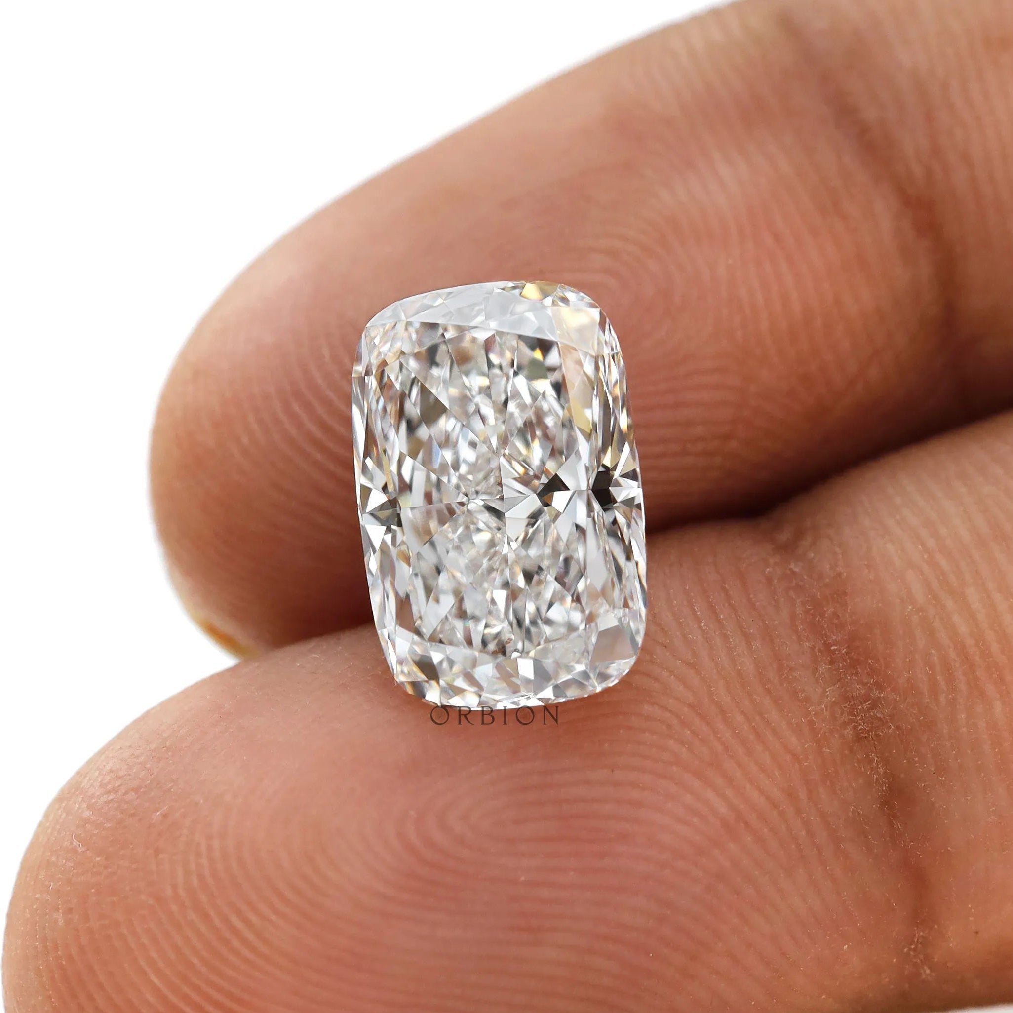 Elongated cushion crushed ice loose lab diamond shown on fingertips