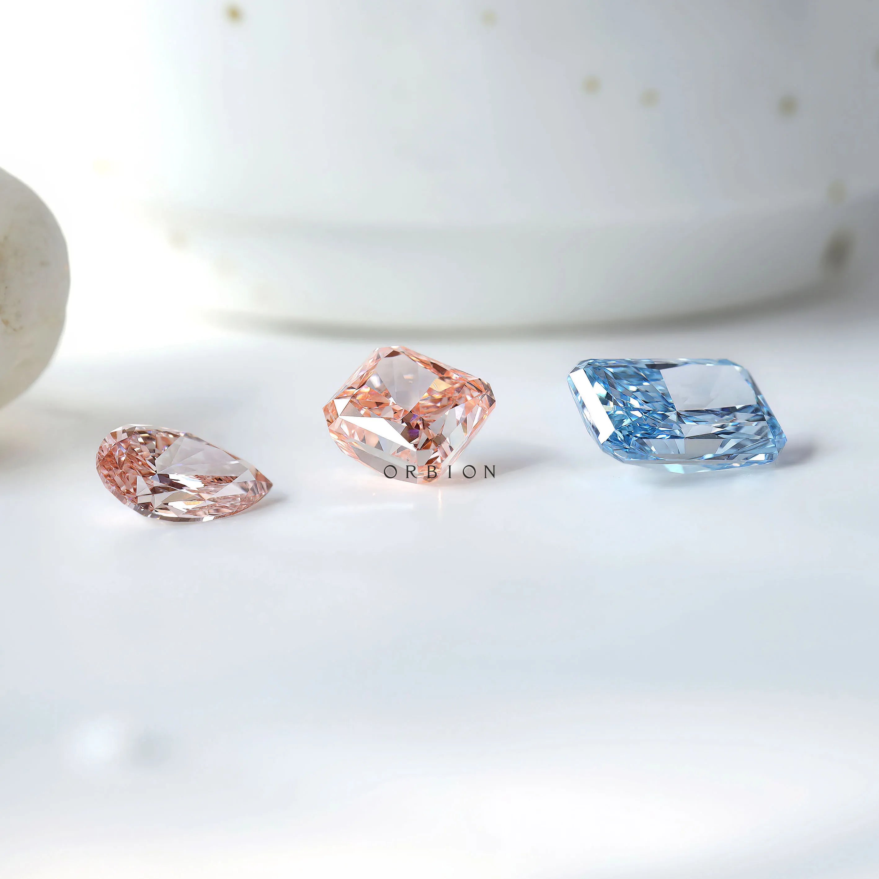 Mixed gemstone display featuring blue radiant lab diamond