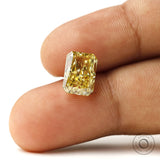 Fancy intense yellow radiant lab diamond shown on fingertip