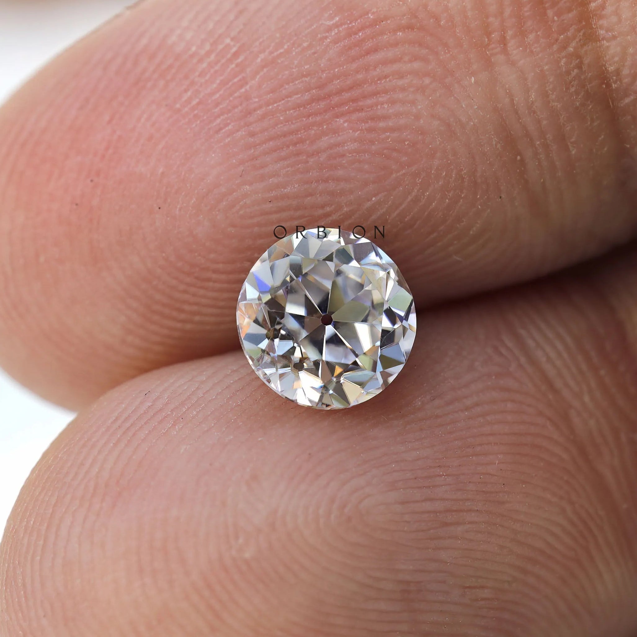 Old European cut round moissanite showing soft vintage sparkle
