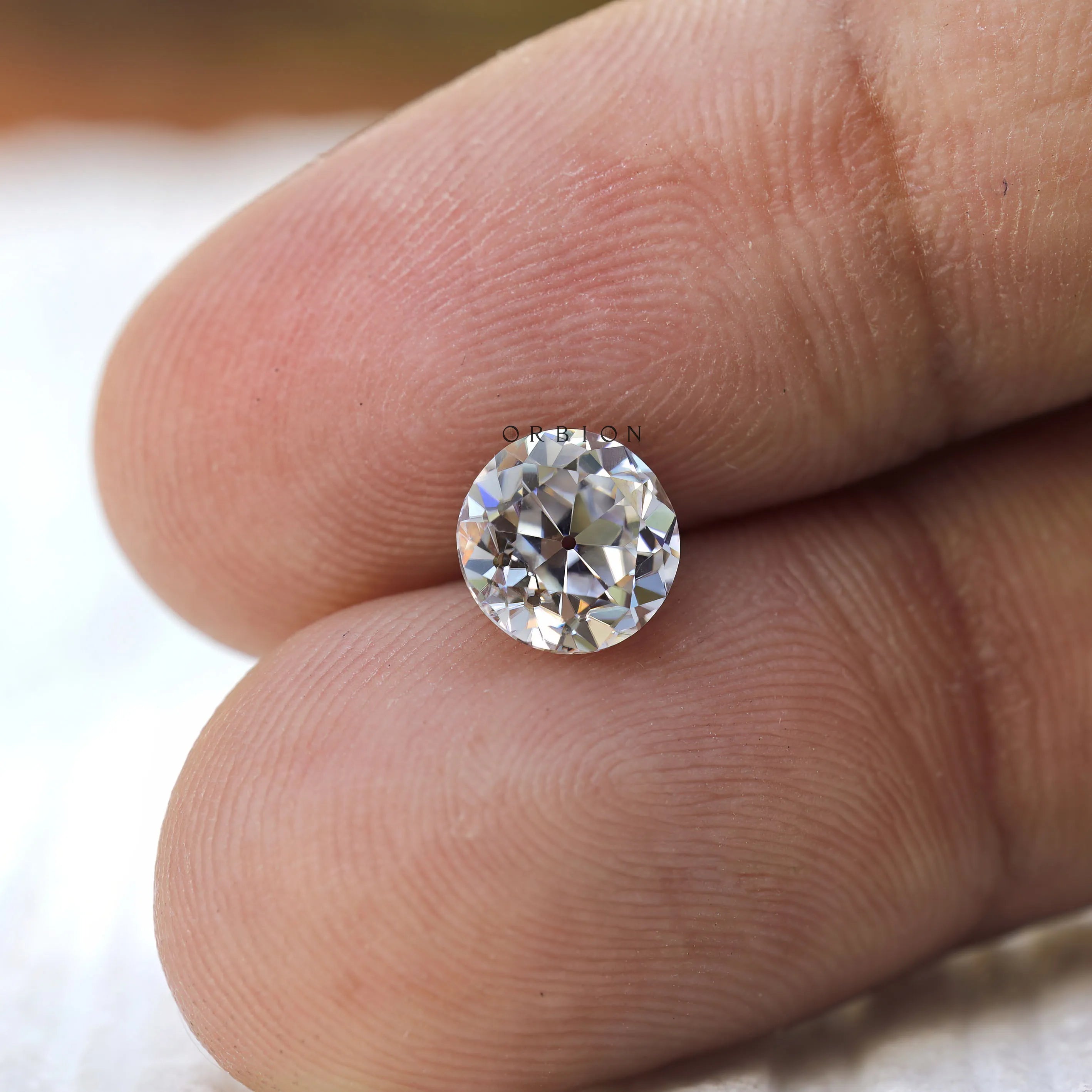 Old European cut round moissanite showing soft vintage sparkle