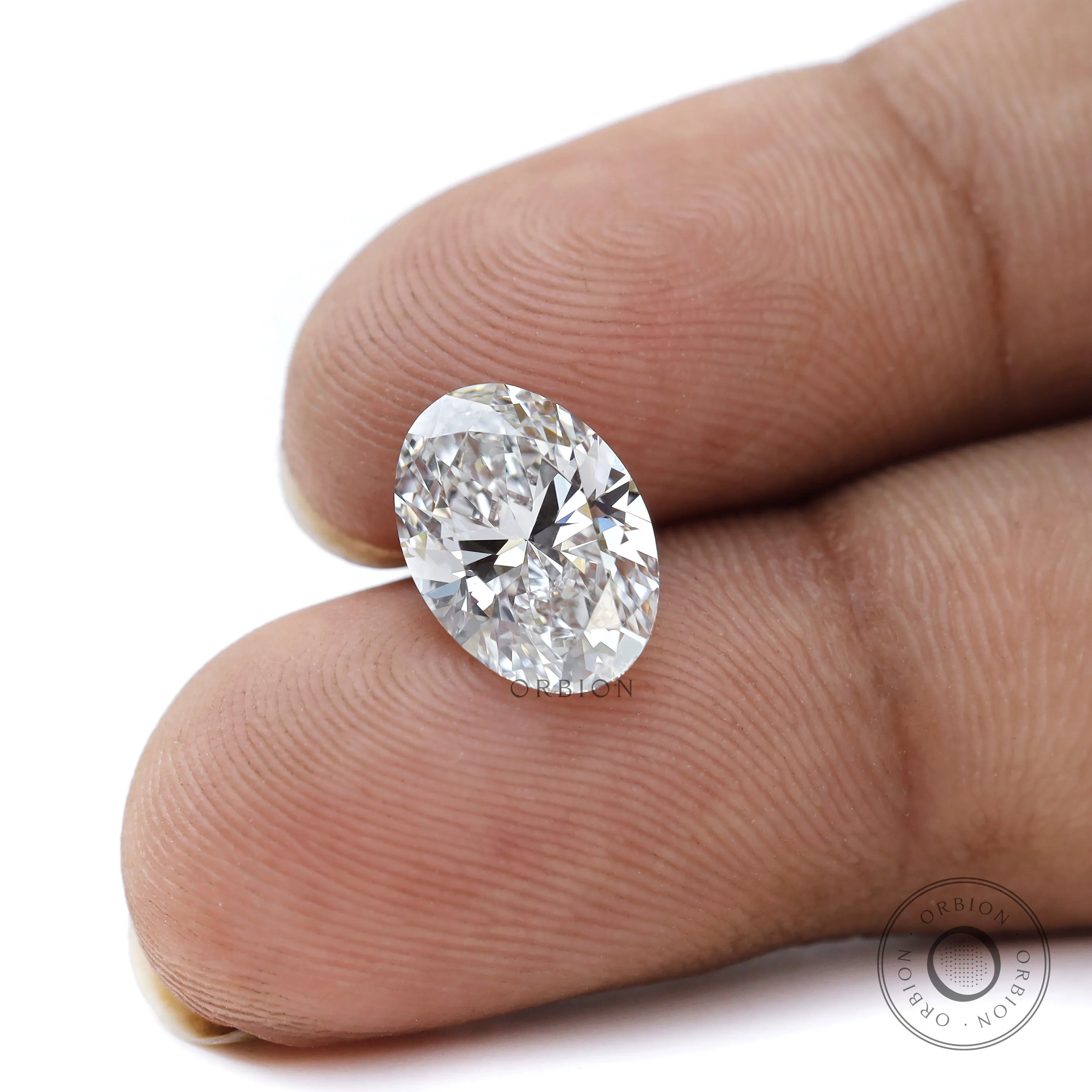 Oval brilliant cut lab diamond displayed between fingers