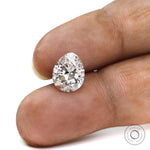 Pear brilliant cut loose lab diamond displayed on fingertips